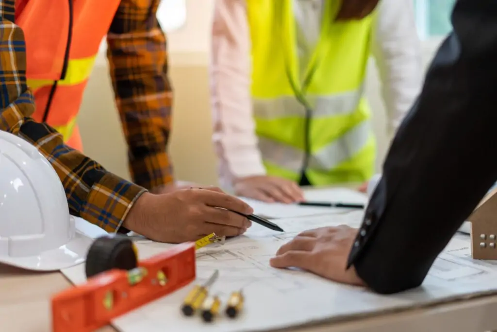 construction-workers-and-real-estate-agent-discussing-building-plans