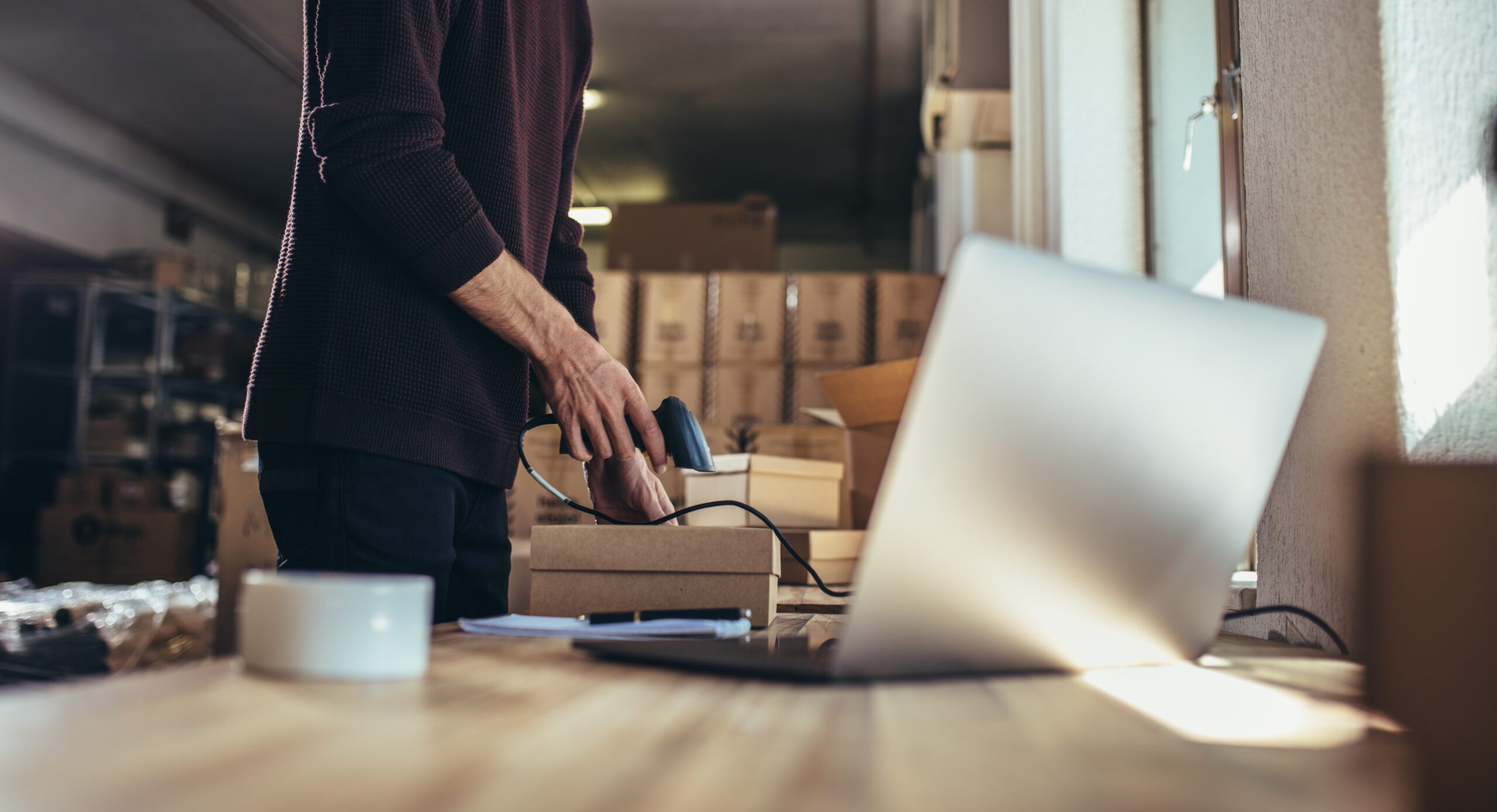 Cropped,Shot,Of,Man,Scanning,The,Barcode,Of,The,Shipment