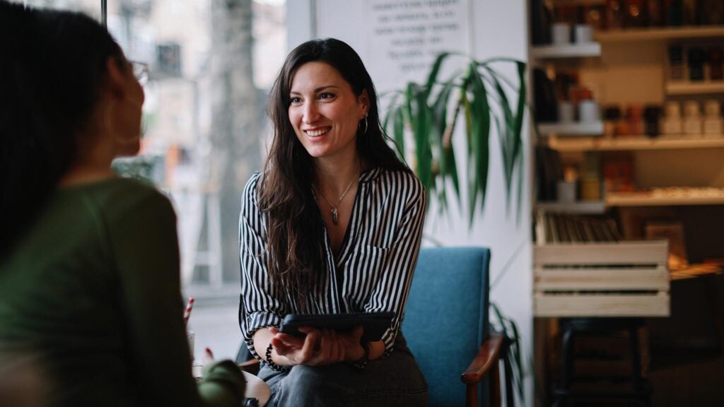 A business owner converses with a lender while determining how to get a business loan.